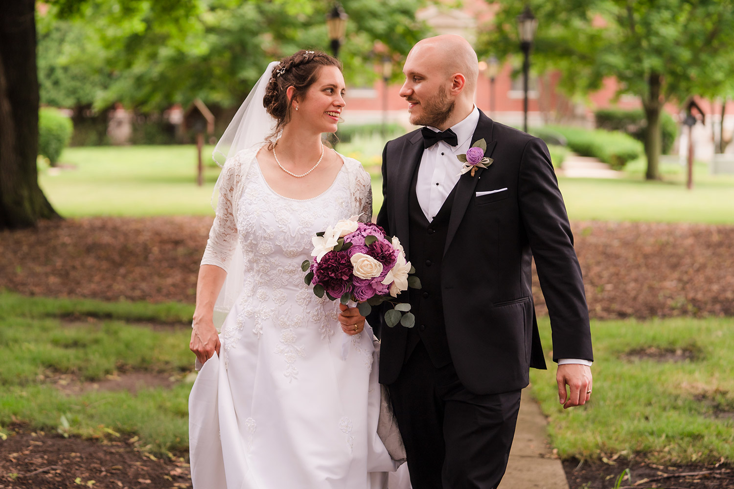 Bride and groom strolling through the National Shrine of St. Maximilian Kobe in Libertyville