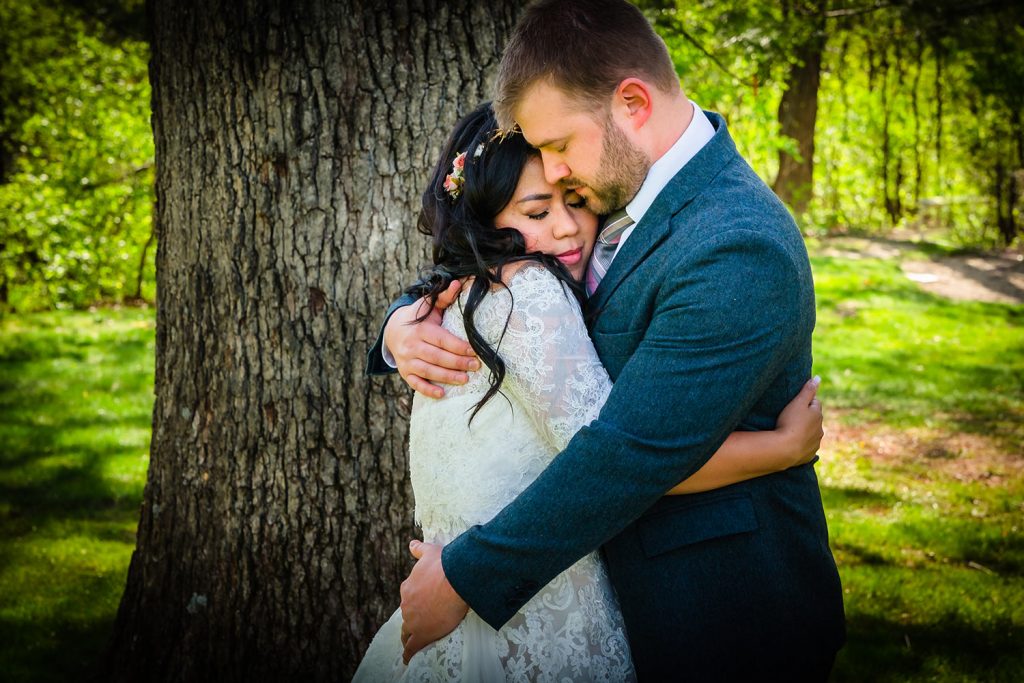 Bride and groom hold each other tightly