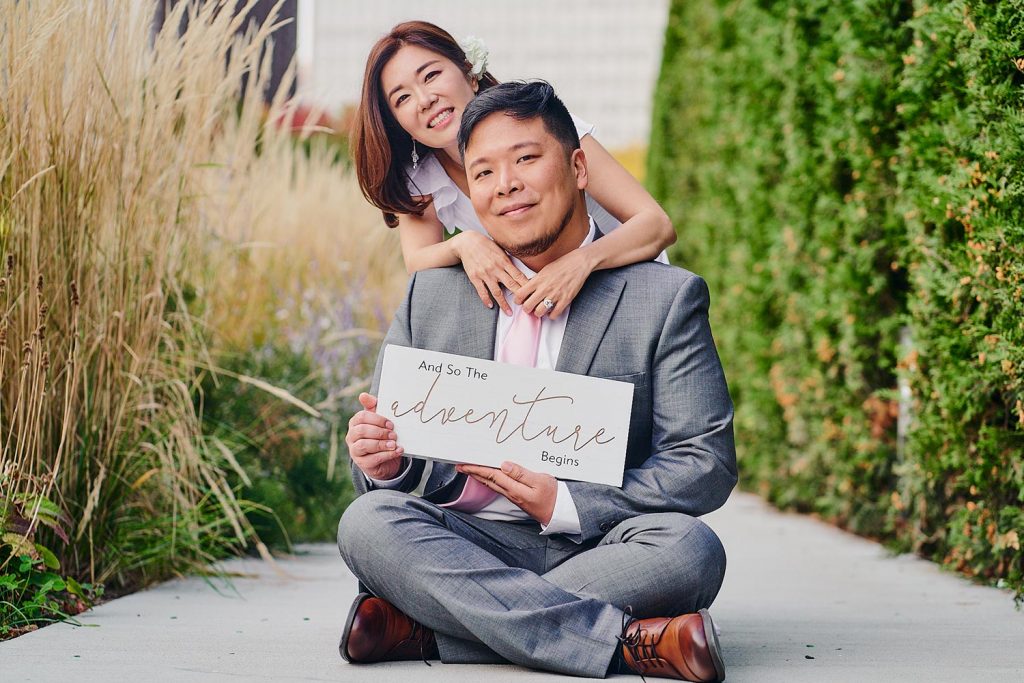 Bride and groom holding a just married sign