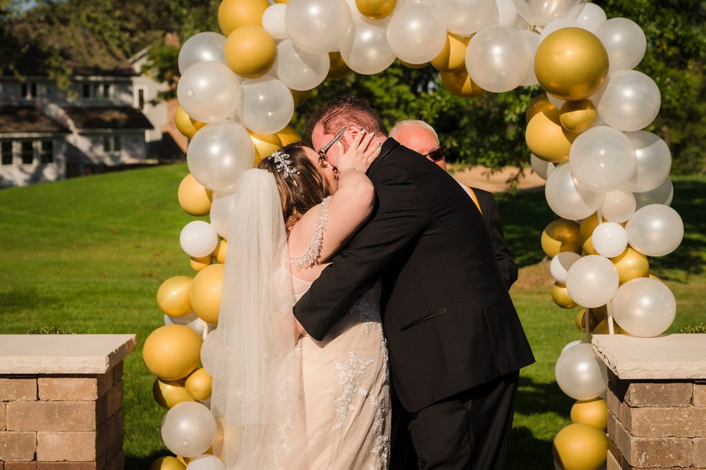 Bride and groom kiss after being pronounced husband and wife in Darien, IL