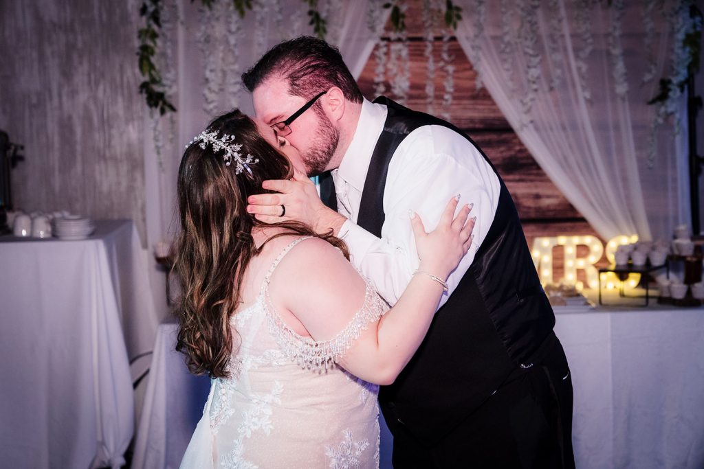 Bride and groom kiss during their first dance at their reception at River Cafe & Bar in River Grove, IL