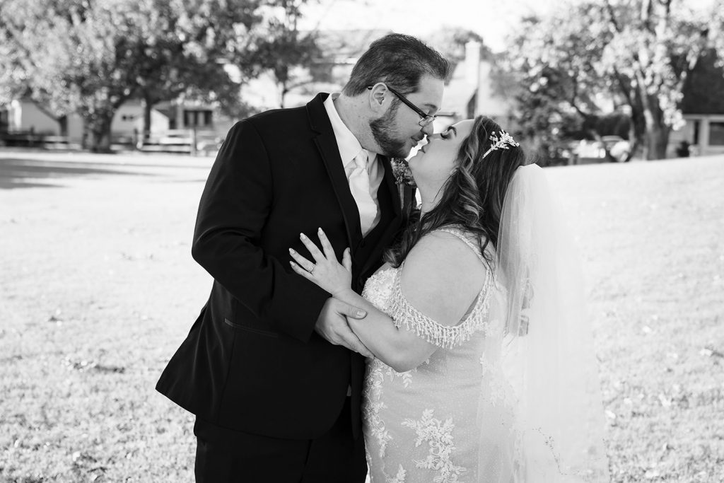 Bride and groom touching noses during wedding portraits in Darien, IL