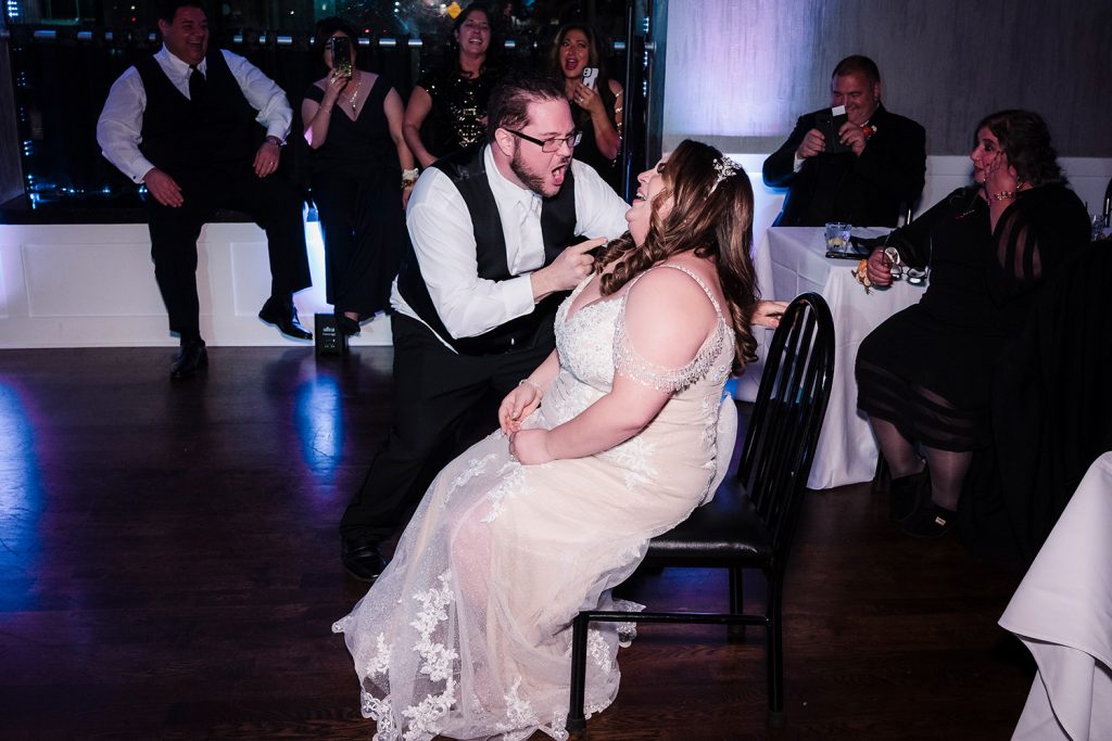 Groom lip synchs "The Best" to his bride during their reception at River Cafe & Bar in River Grove, IL