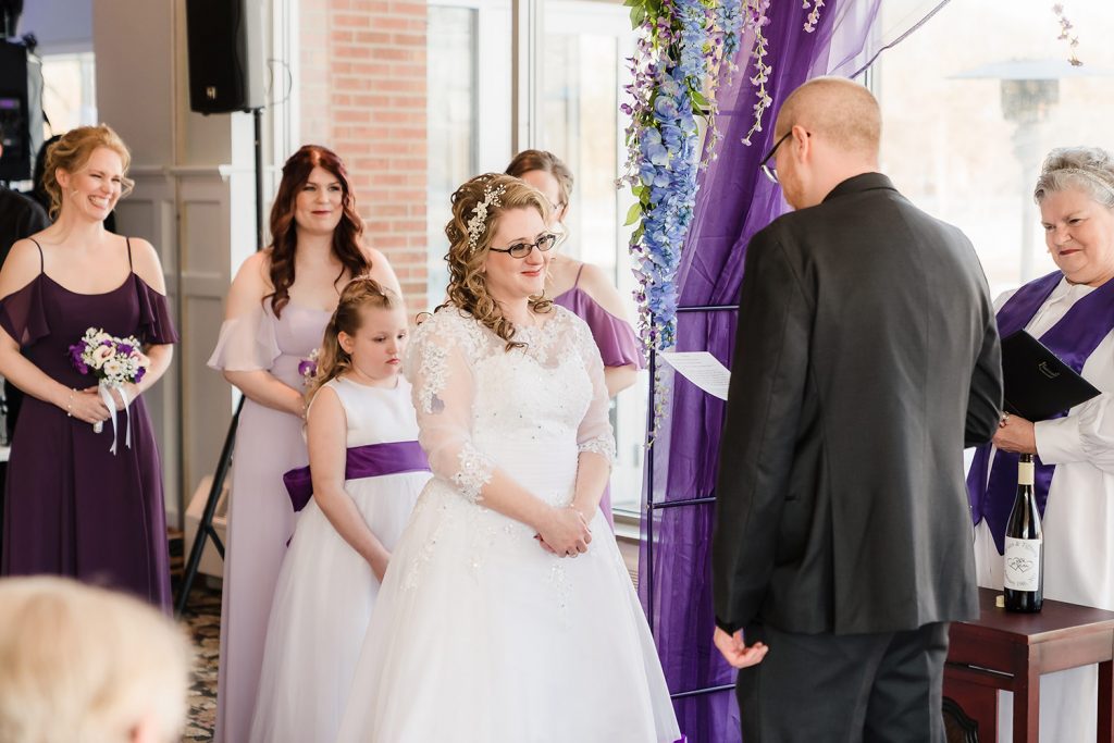 Bride smiling at the groom during the wedding ceremony at Innsbrook Country Club in Merrillville, IN