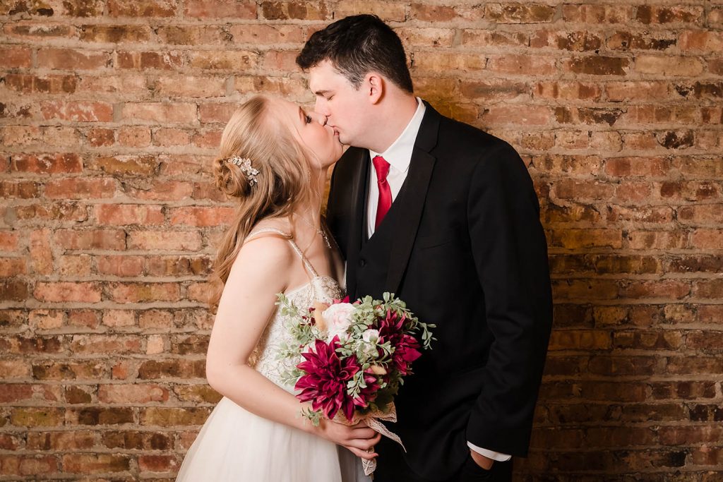 Bride and groom kiss during their couples shoot at The Haight in Elgin, IL