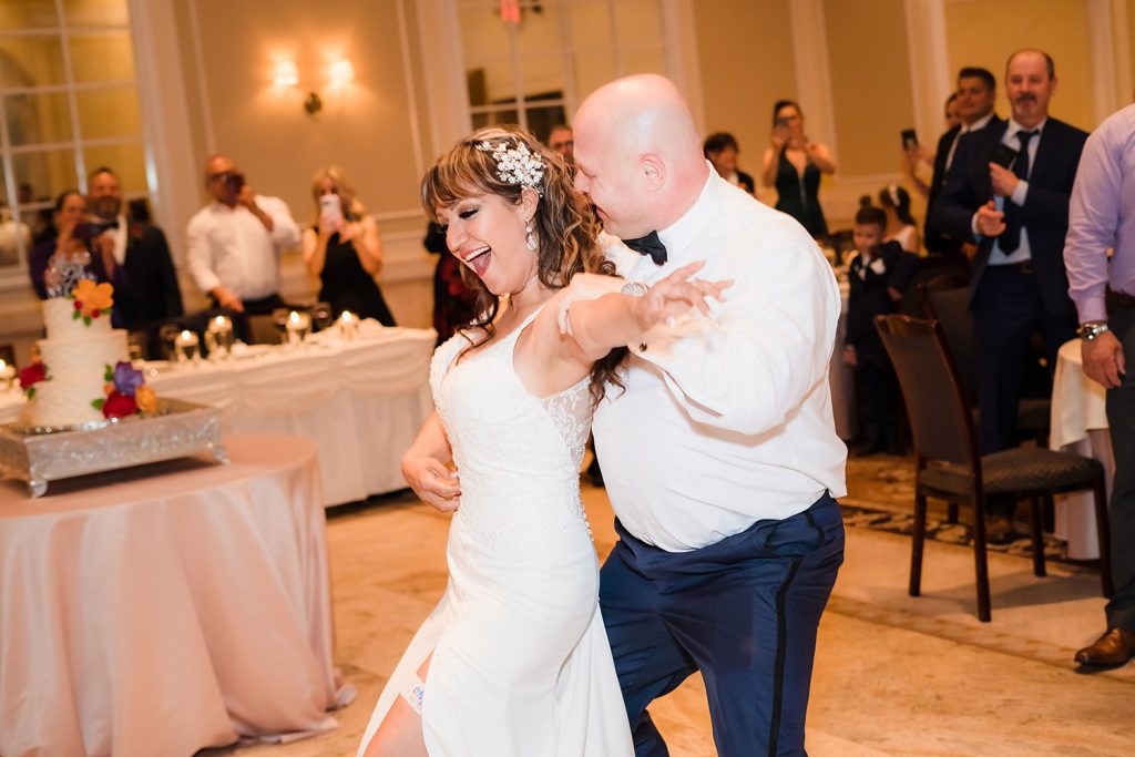 Bride and groom laughs during their first dance as husband and wife at Venuti's in Addison, IL