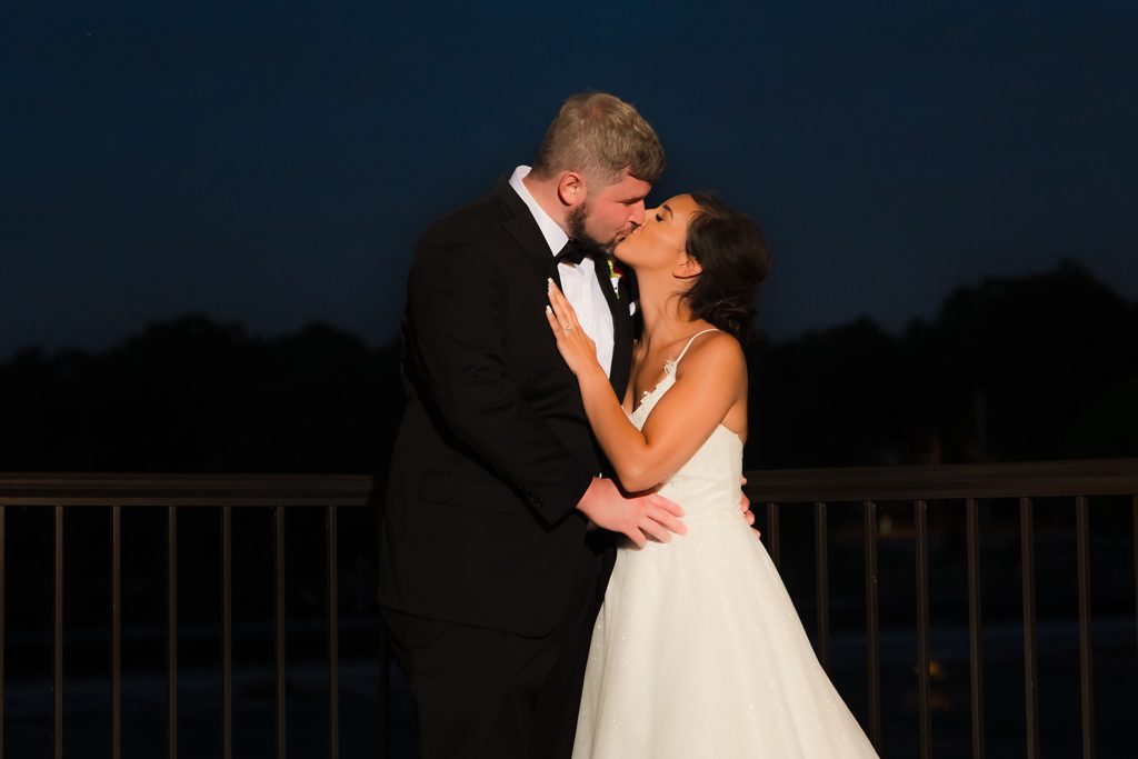 Bride and groom late evening kiss at Riverside Receptions in Geneva, IL