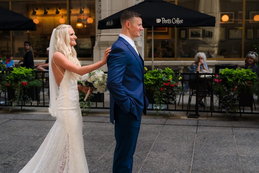 Bride and groom First Look at the Walkway behind the Wrigley Building in Chicago, IL