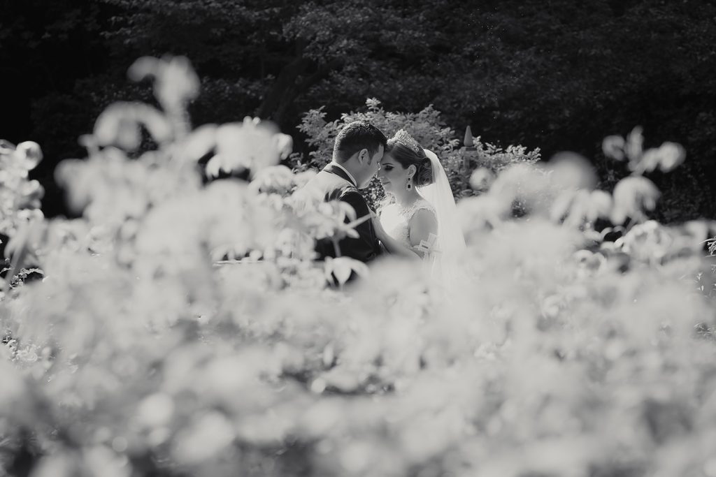 Bride and groom kissing at the Shakespeare Garden in Evanston, IL