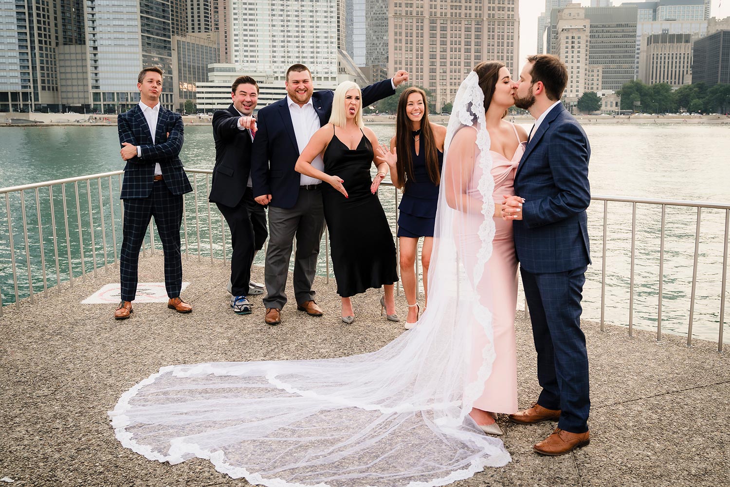 Bridal party cheering on the bride and groom at Milton Lee Olive Park in Chicago