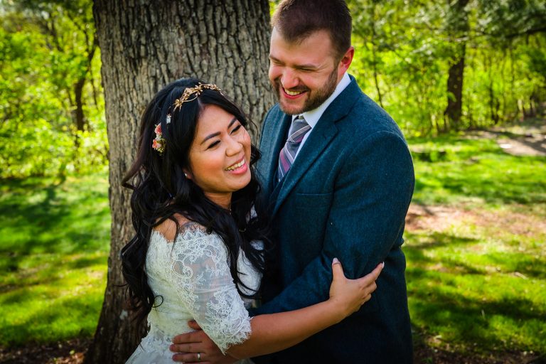 Bride and groom laughing at Kilbuck Creek in Monroe, IL