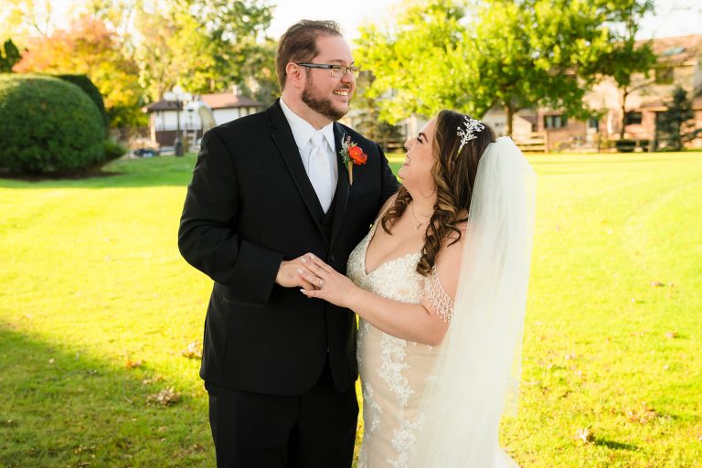 Bride and groom laugh during wedding portraits in Darien, IL