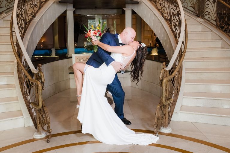 Bride and groom portrait dip at the staircase at Venuti's in Addison, IL