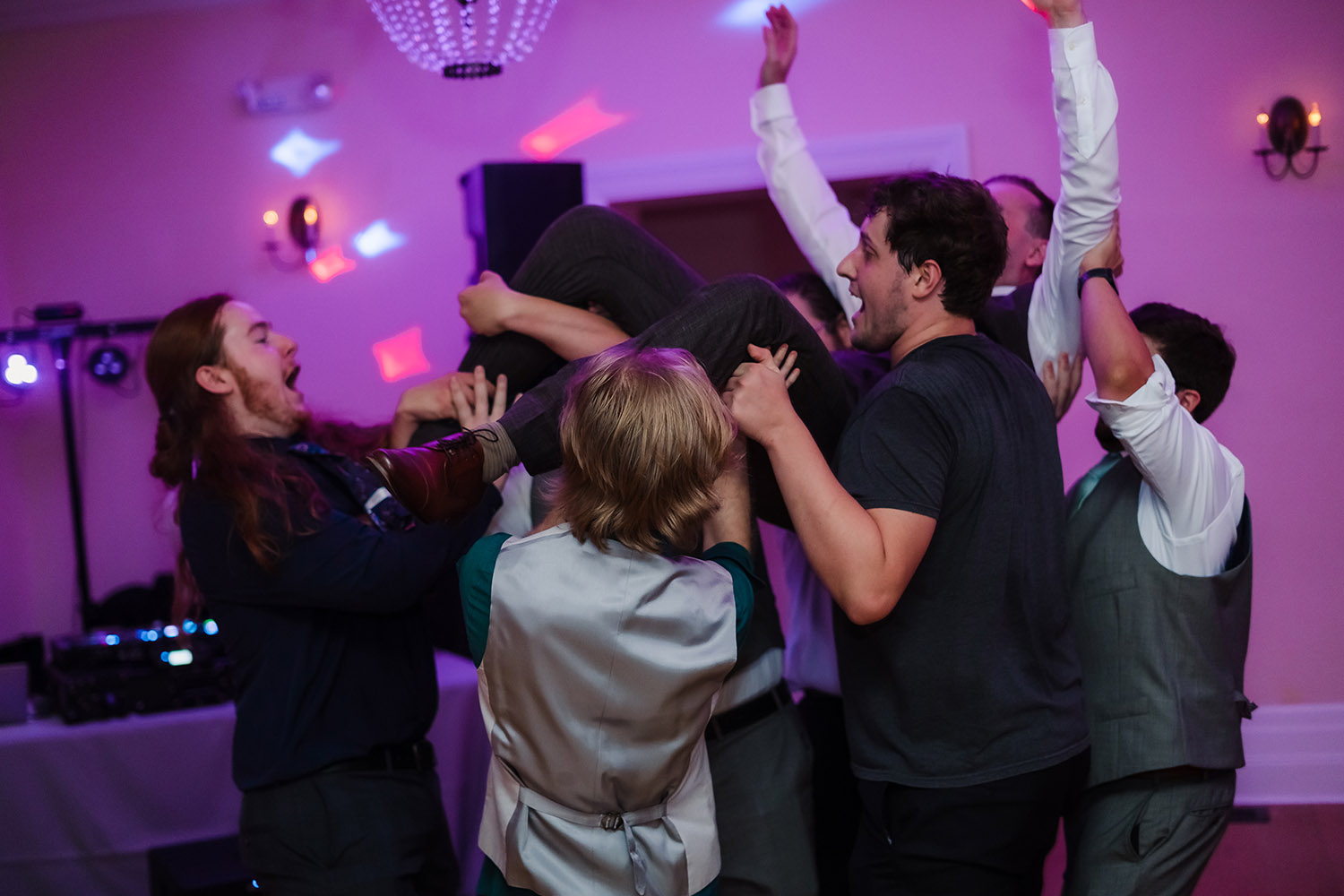 Groom lifted into the air during the reception at Wilder Mansion in Elmhurst, IL