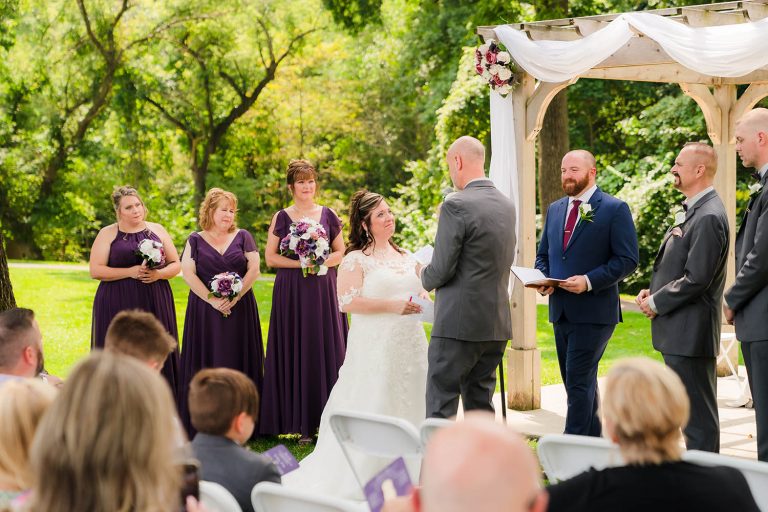 Groom reads vows to his bride at the Bird Haven Greenhouse & Conservatory in Joliet, IL