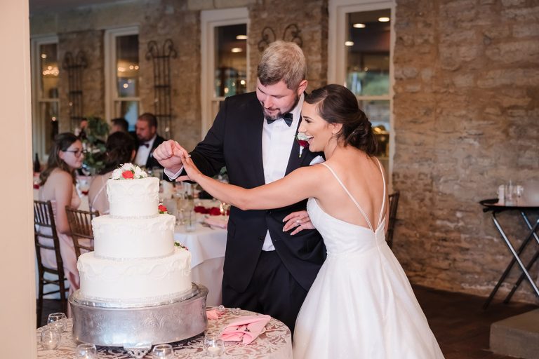 Bride and groom cutting the cake during their reception at Riverside Receptions in Geneva, IL