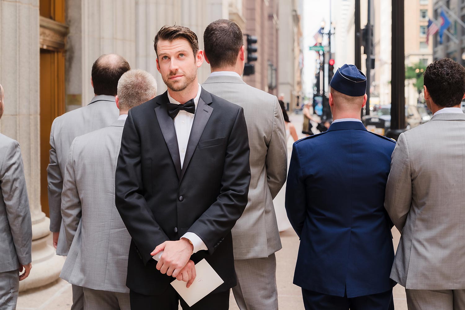 Groom awaits his bride for their first look at LaSalle Street in Chicago, IL