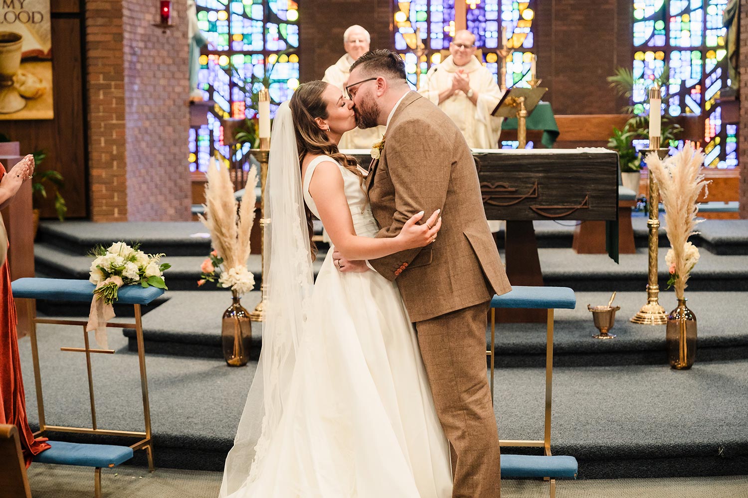 Bride and groom kiss during their wedding ceremony at Our Lady of Peace Catholic Church in Darien, IL