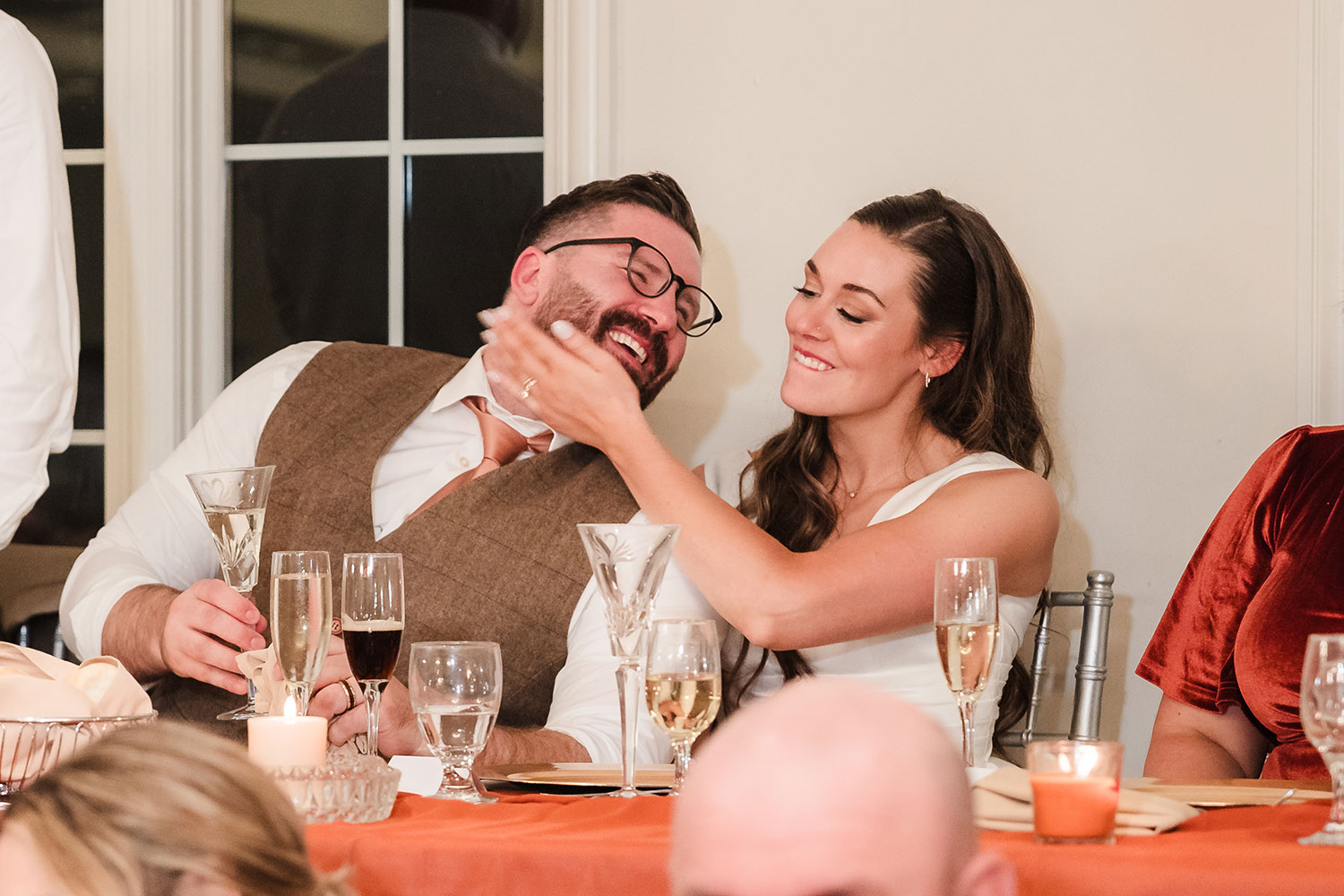 Bride and groom laughing during speeches at their reception at Ruffled Feathers Country Club in Lemont, IL