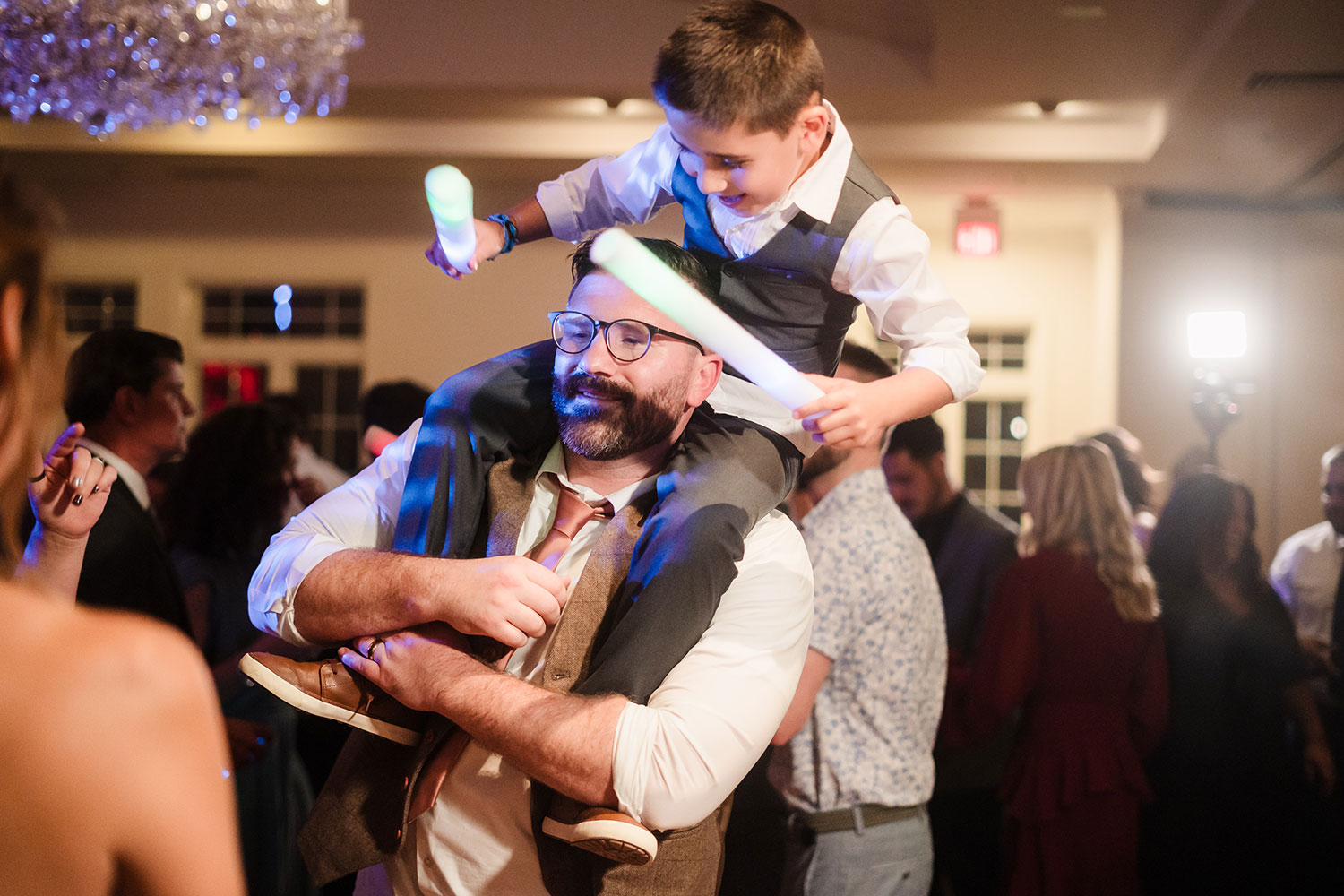 Groom partying with nephew during the reception at Ruffled Feathers Country Club in Lemont, IL