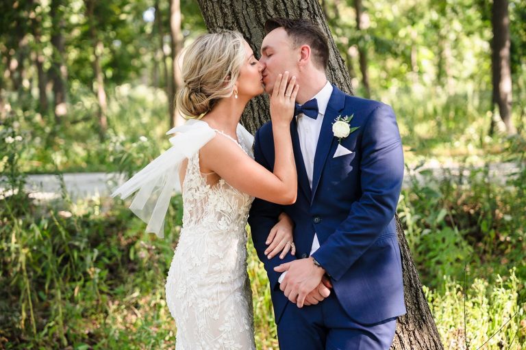 Bride and groom kiss at Oak Brook Tennis & Bath Club in Oak Brook, IL