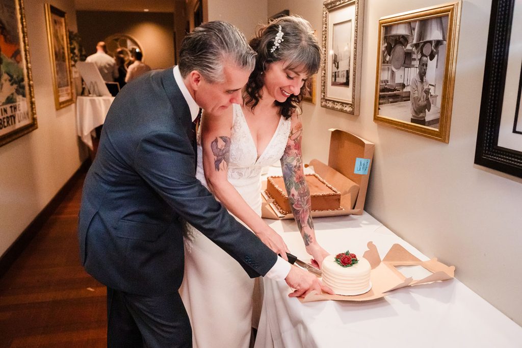 Bride and groom cake cutting at their reception at Victory Tap in Chicago, IL