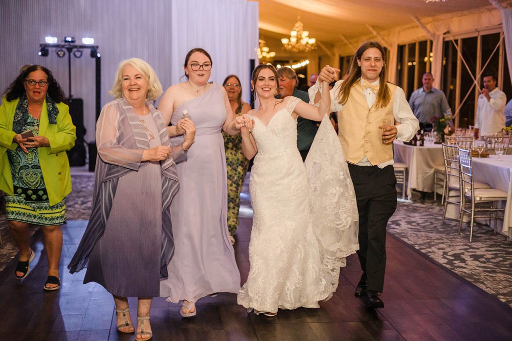 Family strolling through the Soul Train Line during their reception at the Monte Bello Estate in Lemont, IL