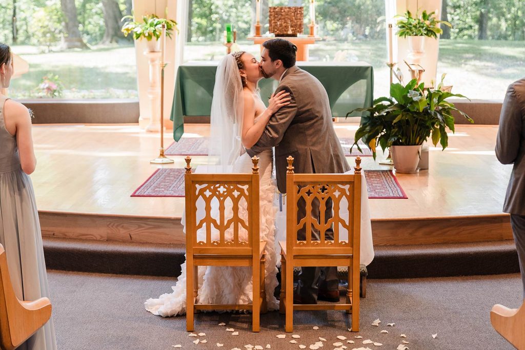 Bride and groom kiss at the end of their ceremony at St. Patrick’s Catholic Church in Wadsworth, IL