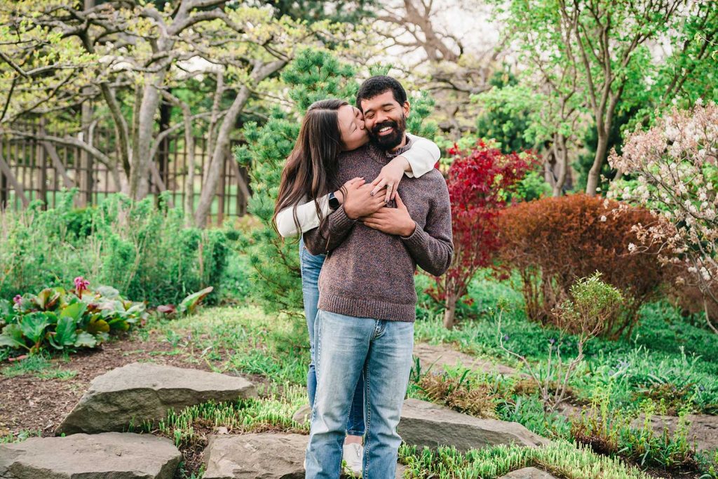 Engaged couple laughing during their engagement session at Garden of the Phoenix in Chicago, IL