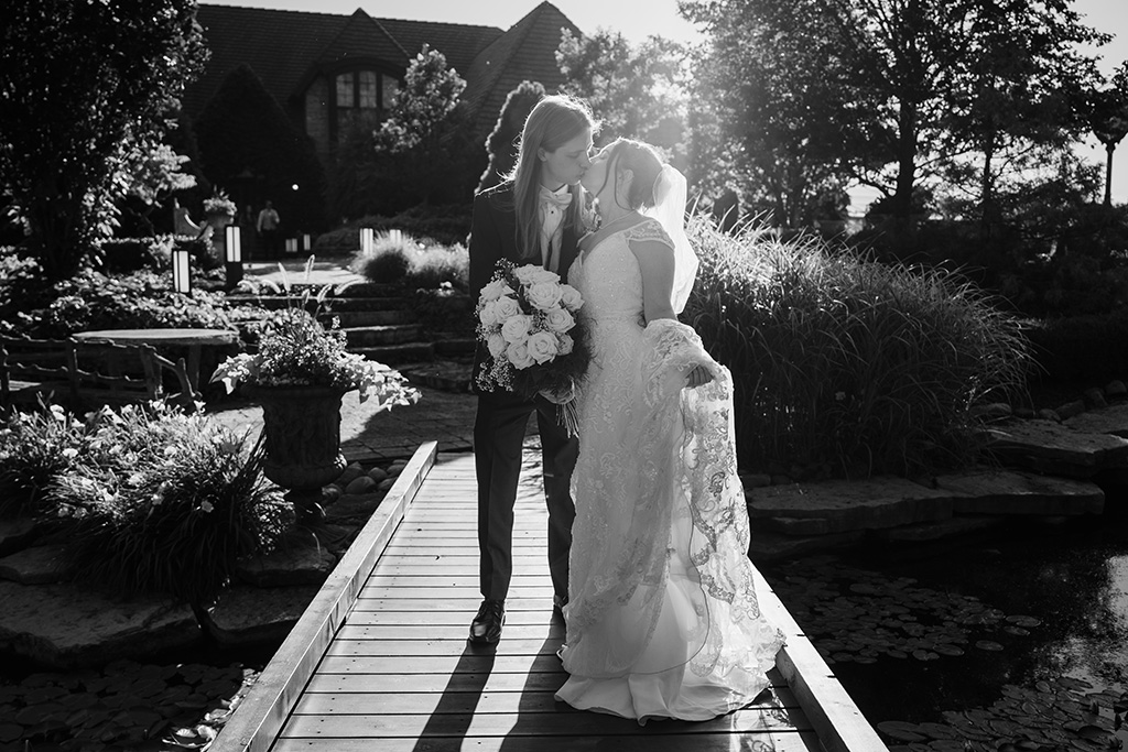 Bride and groom kissing on the bridge at the Monte Bello Estate in Lemont, IL