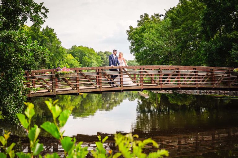 Bride and groom portrait on bridge at Towers Lake, IL