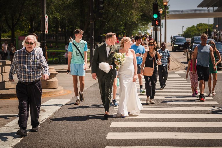 Bride and groom walking on Michigan Avenue in Chicago, IL