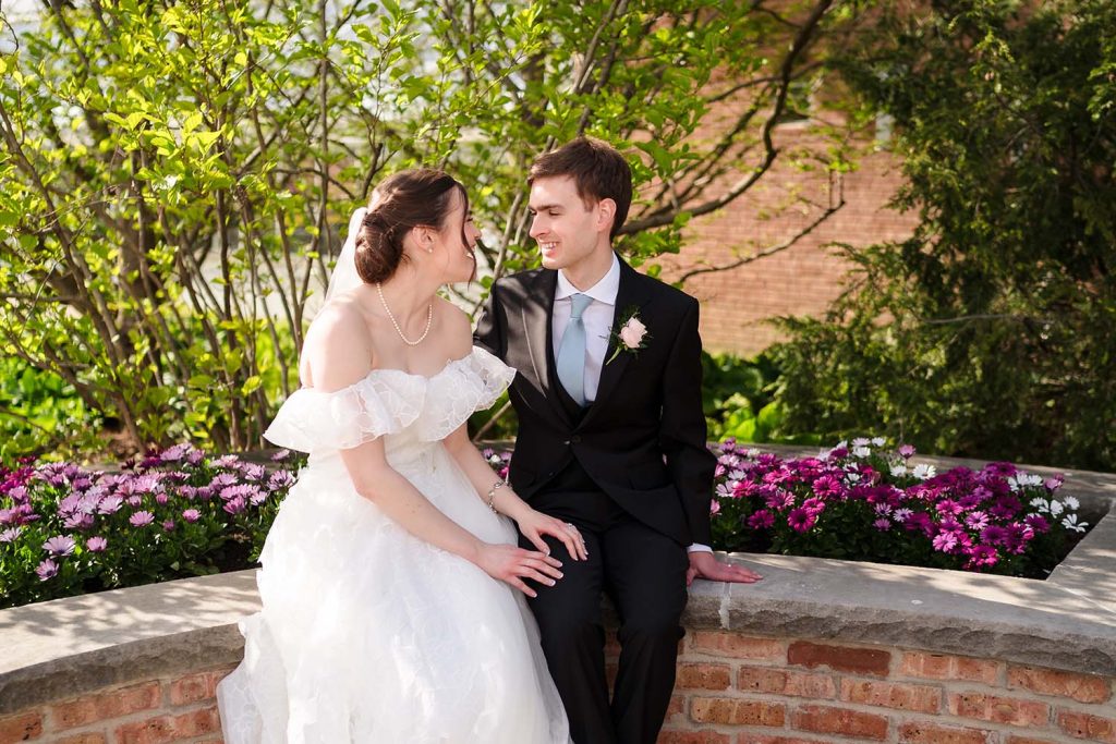 Bride and groom smiling at each other in the garden at Wilder Park in Elmhurst, IL