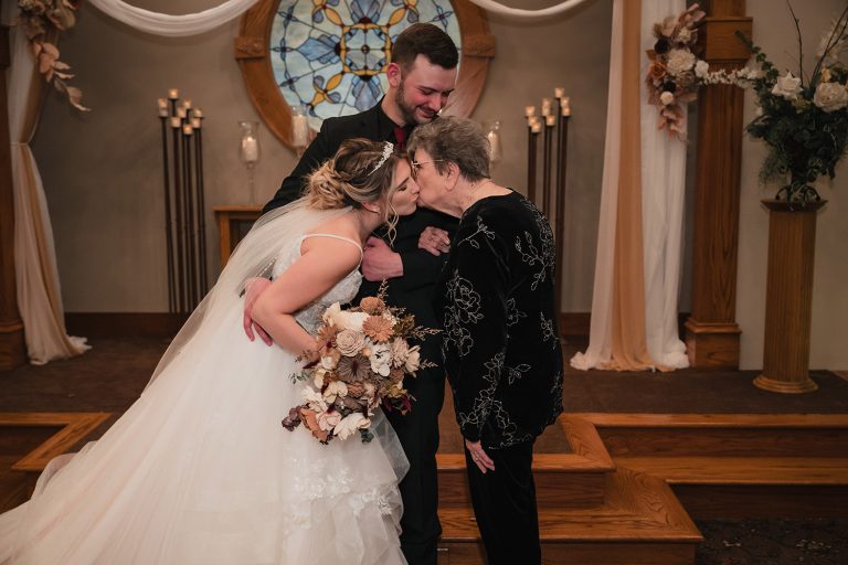 Bride kisses her grandparent during family portraits at Aberdeen Manor Ballroom in Valparaiso, IN