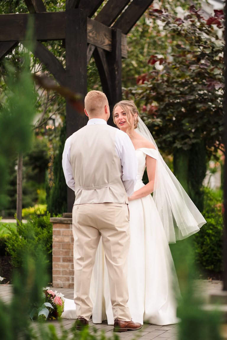 Bride tears up while reading private vows during a first look at The Farmhouse in Plainfield, IL