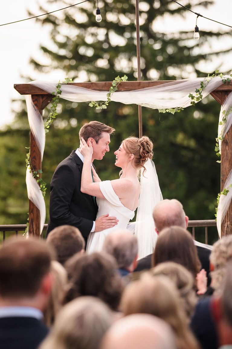Bride gently touches the groom’s face during their wedding ceremony at Bartlett Hills Golf Club in Bartlett, IL