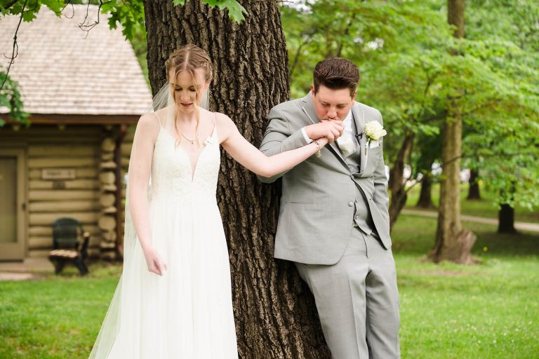 Groom kisses the bride’s hand during their first touch at Starved Rock Lodge in Utica, IL