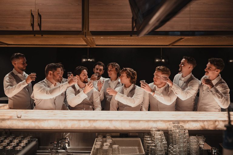 Groomsmen raise a toast to the groom at Bar Louie inside the Chicago Marriott Northwest in Hoffman Estates, IL