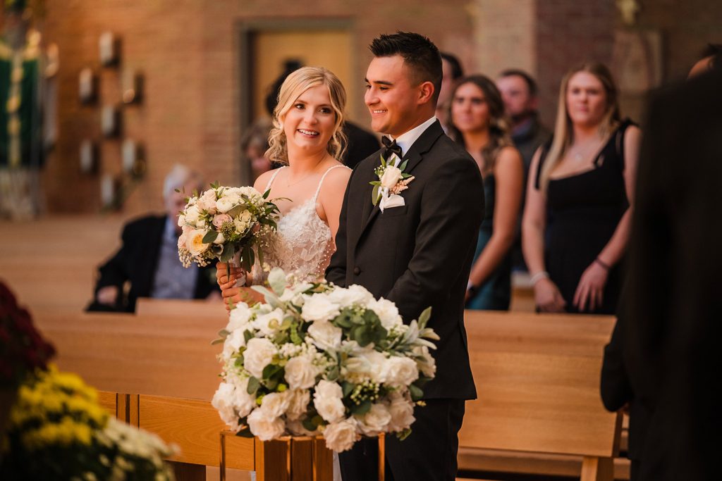 Bride and groom standing together during their wedding ceremony at St. Patrick Parish in Yorkville, IL