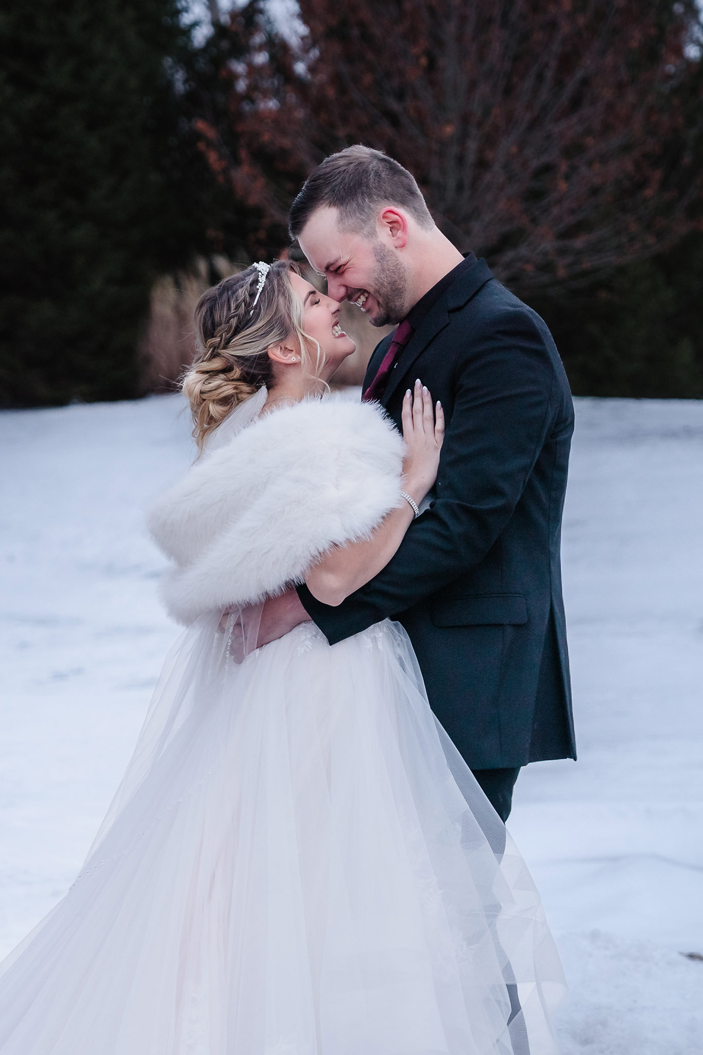Wedding couple sharing a quiet embrace in the snow at Aberdeen Manor Ballroom in Valparaiso, IN
